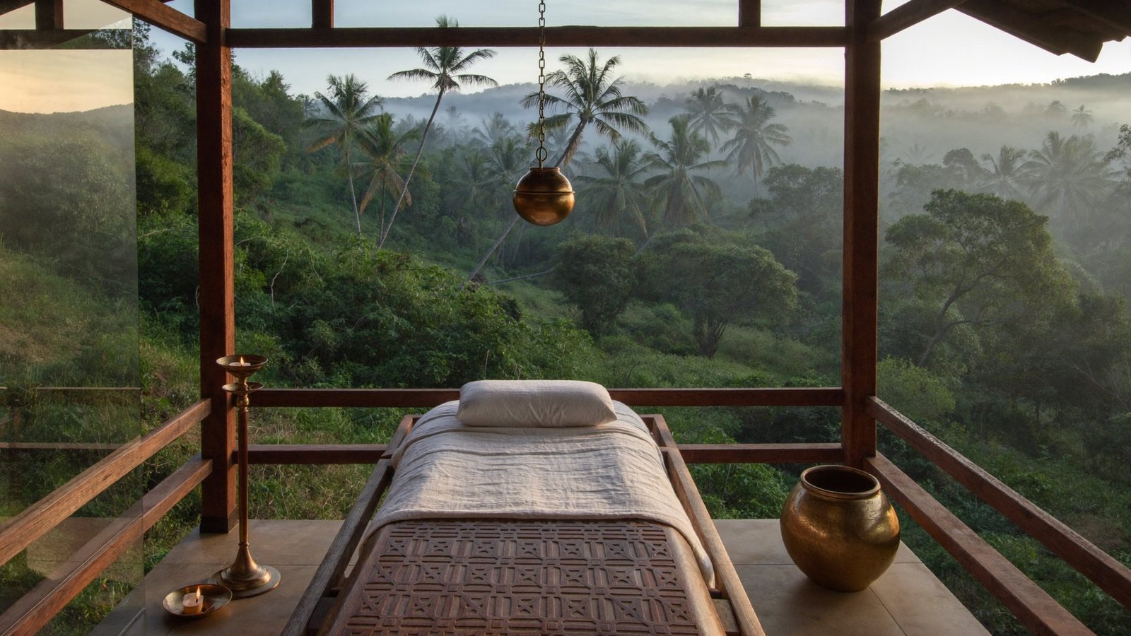 Open Ayurveda pavilion at Vaidekam at dawn, surrounded by greenery